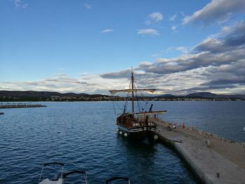 Boat moored on sea against sky