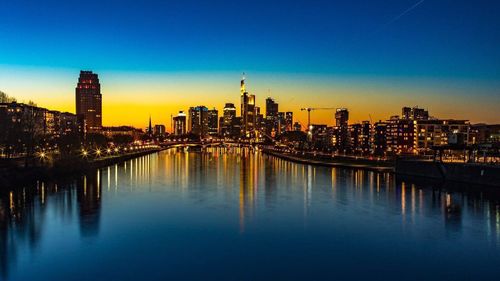 View of city at waterfront during sunset