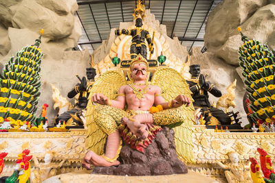 Low angle view of statue against temple