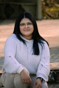 Portrait of smiling woman sitting outdoors