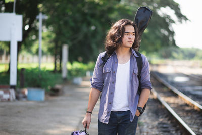 Young couple standing on railroad track