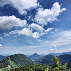 Scenic view of mountains against cloudy sky