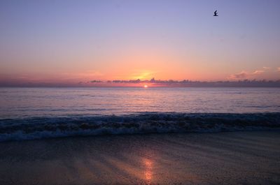 Scenic view of sea against sky at sunset