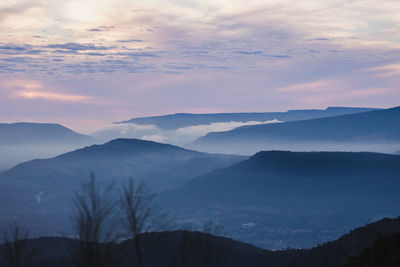 Scenic view of silhouette mountains against sky during sunset