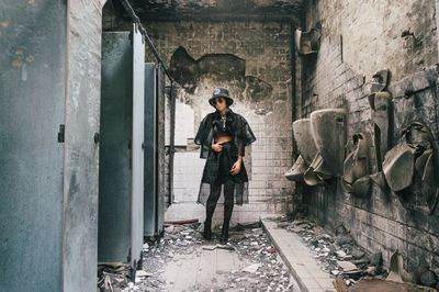 Full length of woman standing in old building