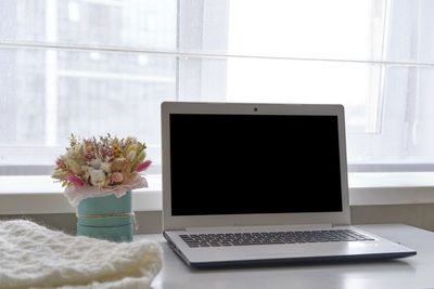 Close-up of flower vase on table