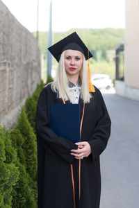 Portrait of woman wearing graduation gown