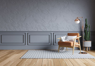 Empty chairs and table against wall at home