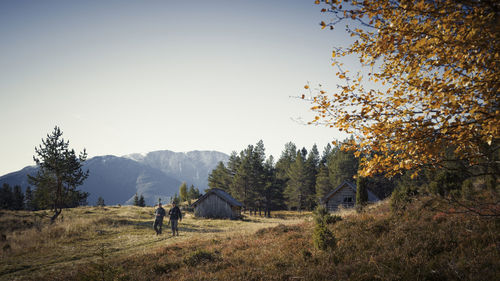 Hunters walking in mountain landscape