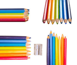 Multi colored pencils in row against white background