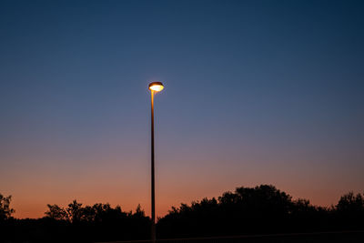 Low angle view of street light against sky during sunset