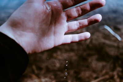 Close-up of hand over water