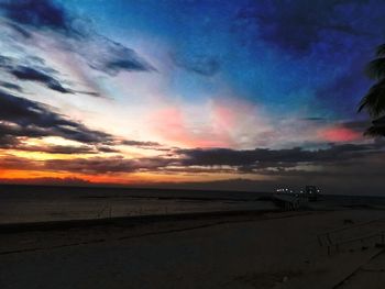 Scenic view of beach against sky during sunset