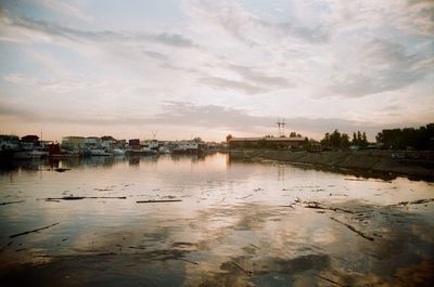 Scenic view of river against sky at sunset