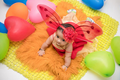 High angle view of cute girl in fairy costume at home