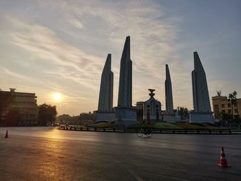 Buildings in city against sky during sunset
