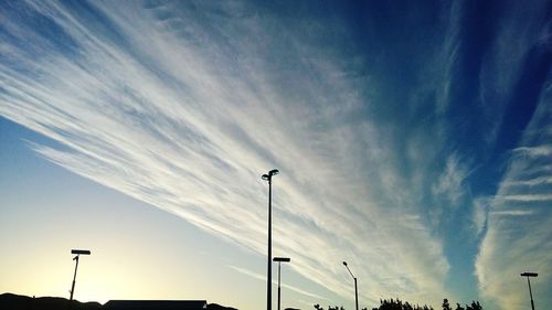 Low angle view of street light against blue sky