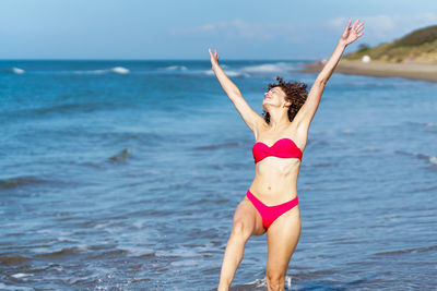 Full length of woman in bikini at beach