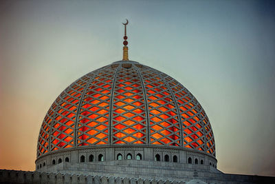 Low angle view of illuminated building against sky