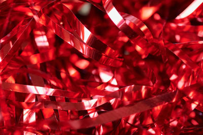 Party red tinsel, holiday background. gift box decorative filler. colorful backdrop design