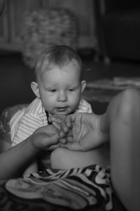 Portrait of cute baby girl sitting at home