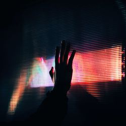 Close-up of hand holding illuminated light at night