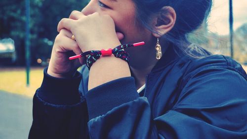 Close-up of young woman with hands