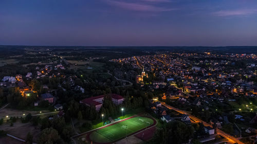 High angle view of illuminated cityscape against sky