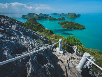 High angle view through rock and steep hiking trail to stunning islands .mu koh ang thong, thailand.