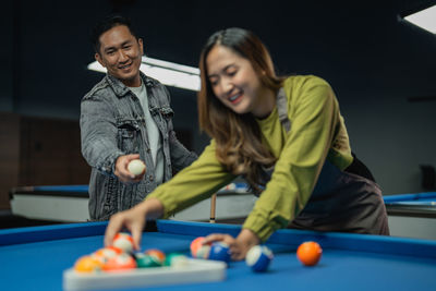 Portrait of woman playing pool