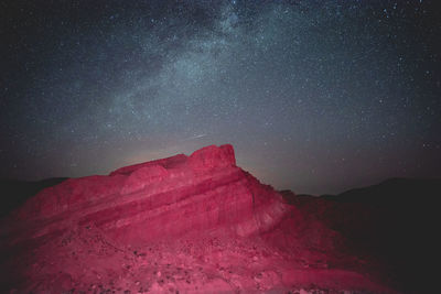 Scenic view of mountain against sky at night