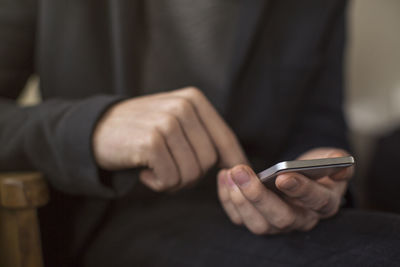 Close-up of man using mobile phone