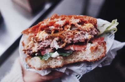 Close-up of hand holding burger