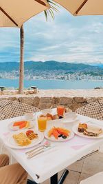 High angle view of breakfast on table at beach