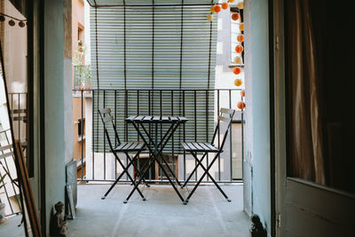 Empty cool and bohemian balcony with chairs and table. there is no people and green wooden  