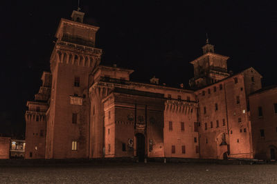 Illuminated building against sky at night