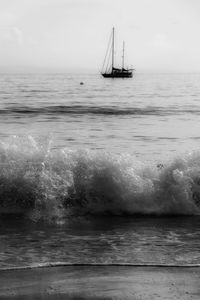 Sailboat sailing on sea against sky