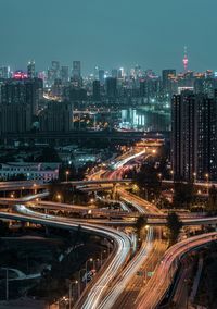 High angle view of illuminated buildings in city at night