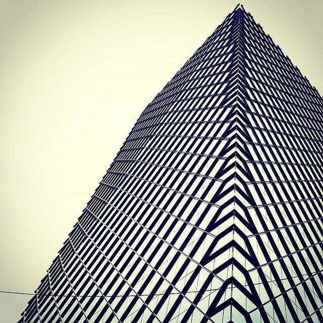 building exterior, low angle view, architecture, built structure, modern, clear sky, office building, tall - high, skyscraper, pattern, tower, city, building, copy space, repetition, design, day, outdoors, no people, sky