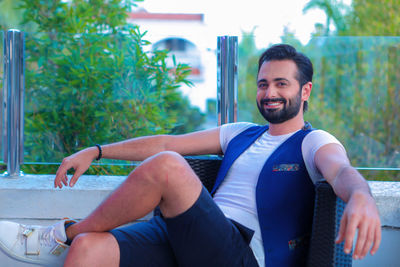 Portrait of young man sitting outdoors