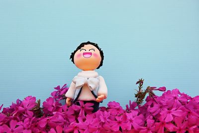 Close-up of pink toys against blue sky