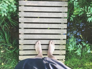 Low section of woman relaxing on grass