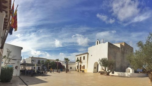 Street amidst buildings in city against sky