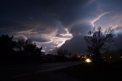 Dramatic sky over road at night