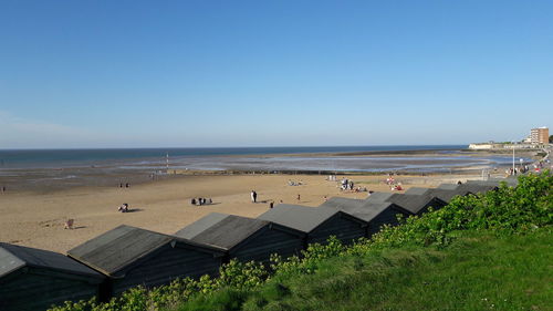 Scenic view of beach against clear blue sky