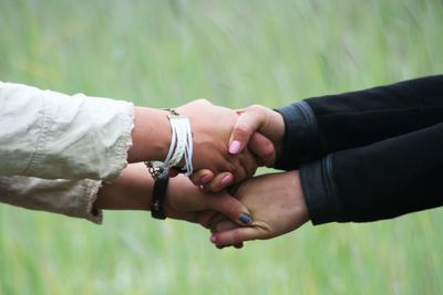 Close-up of couple holding hands