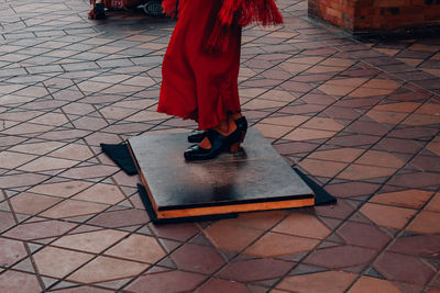 Low section of woman walking on footpath