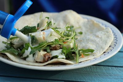 Close-up of salad in tortilla on table