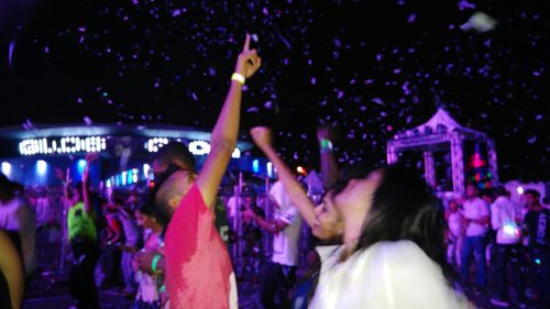 People enjoying music concert at night