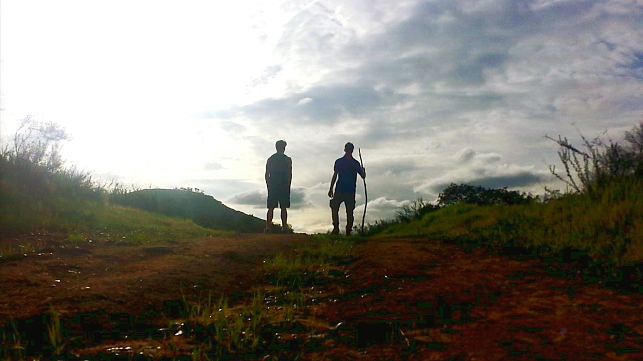 REAR VIEW OF PEOPLE WALKING ON LANDSCAPE